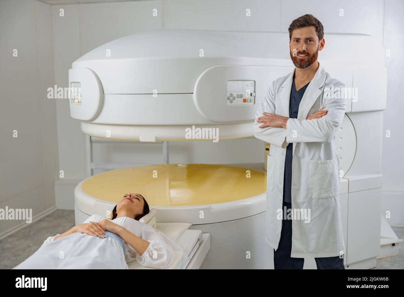 Radiologist on background of MRI or CT or PET Scan with female patient