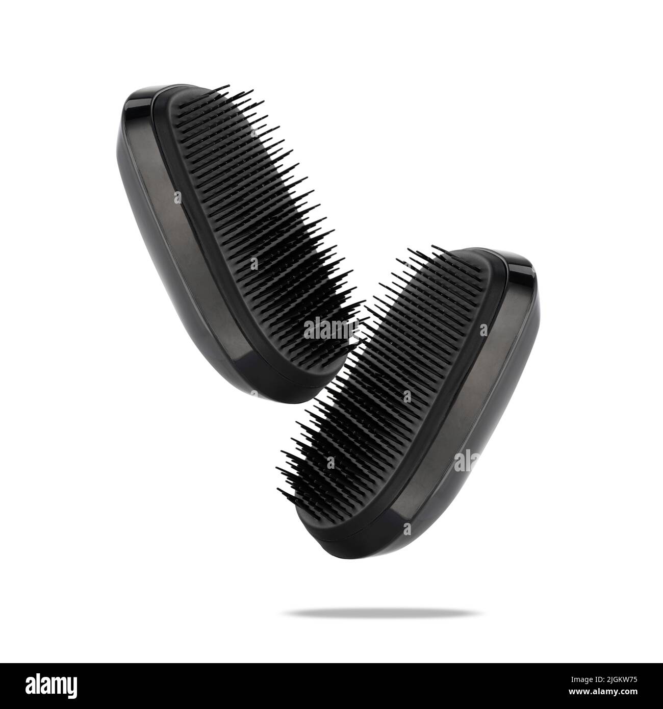 Two detangler hairbrushes float on white. A combs for detangling and caring for hair and scalp in the air. Accessory for a lather shampoo and headskin Stock Photo