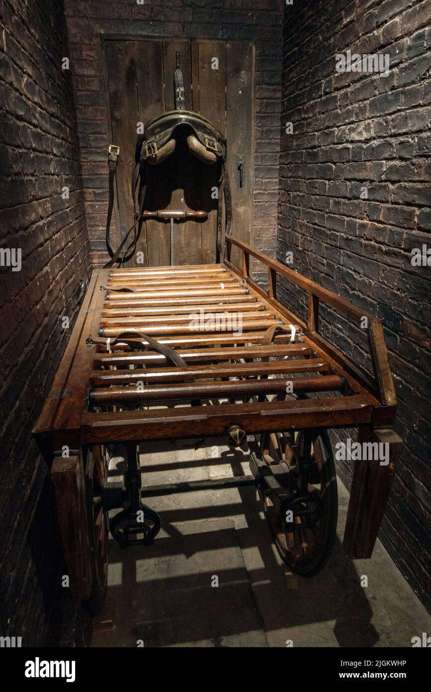 Horse cart for carrying a coffin in a Victorian funeral parlour inside the Abbey House Museum, Kirkstall, West Yorkshire, UK.on the display in the UK. Stock Photo