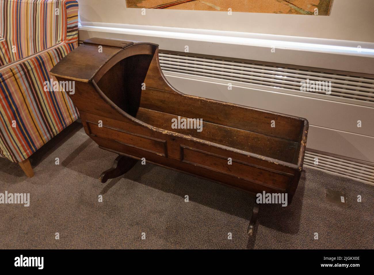 A wooden rocking crib on display in a museum in the UK Stock Photo - Alamy
