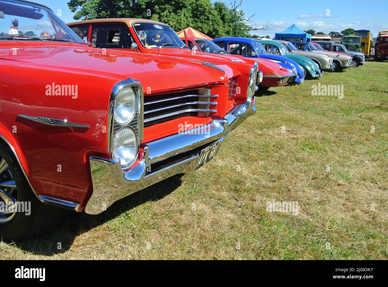 A line of classic cars parked on display at the 47th Historic Vehicle