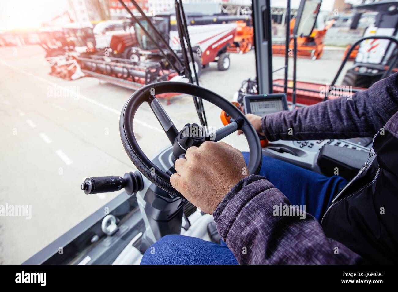 Inside harvester tractor. Steering wheel. View from work place Stock
