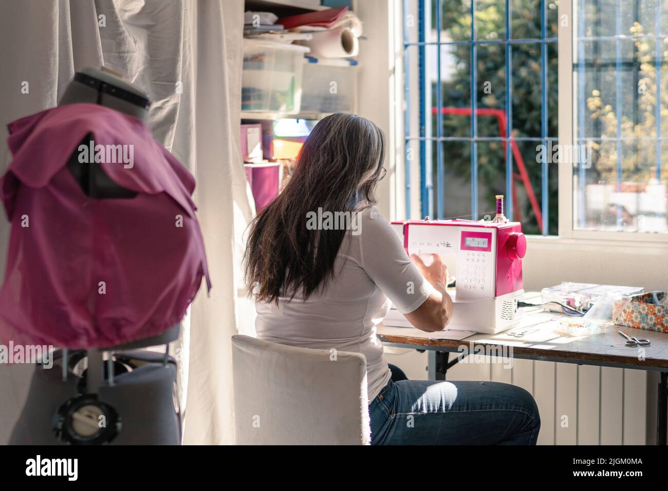 seamstress working at home with a sewing machine Stock Photo Alamy