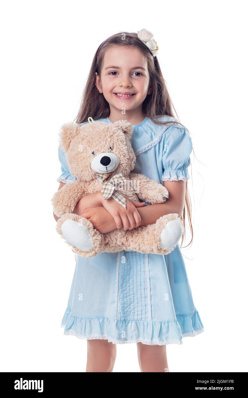 Happy beautiful girl with his favorite toy fluffy friend teddy bear. Childhood and toys. Stock Photo