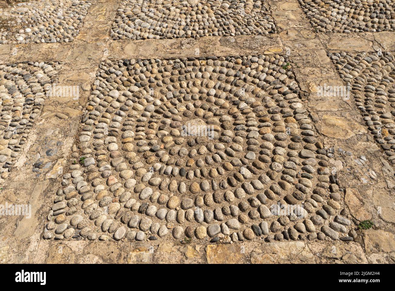 A beautiful stone pattern on a village square in Italy Stock Photo
