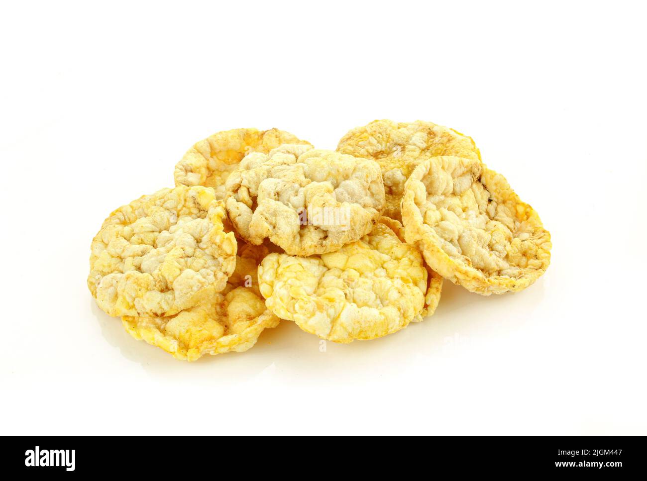 Stack of thin corn rice cracker chips isolated on white background