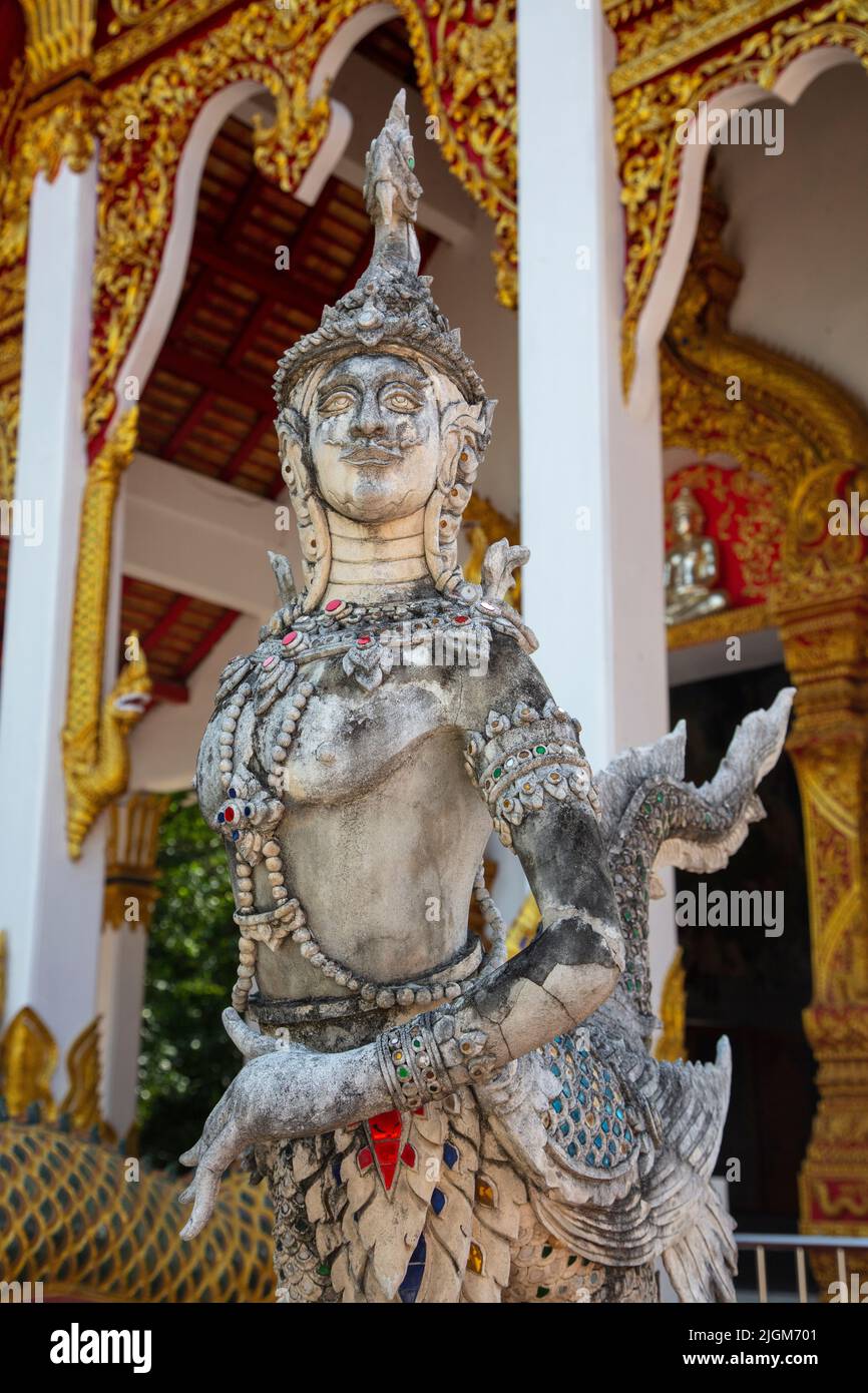 Thai god at the entrance of a Buddhist temple near the ancient village ...