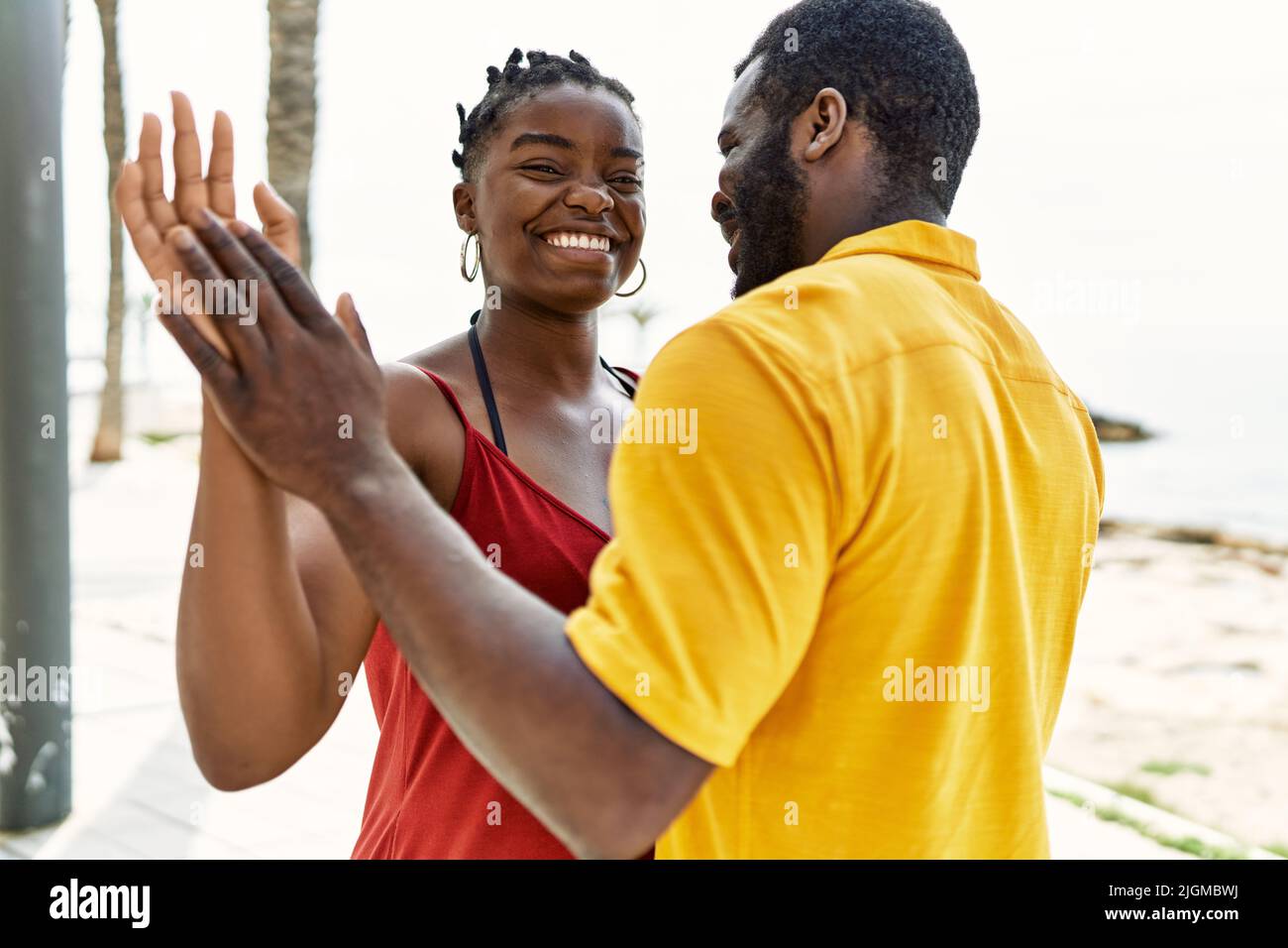 Young african american couple smiling happy dancing at the beach Stock ...