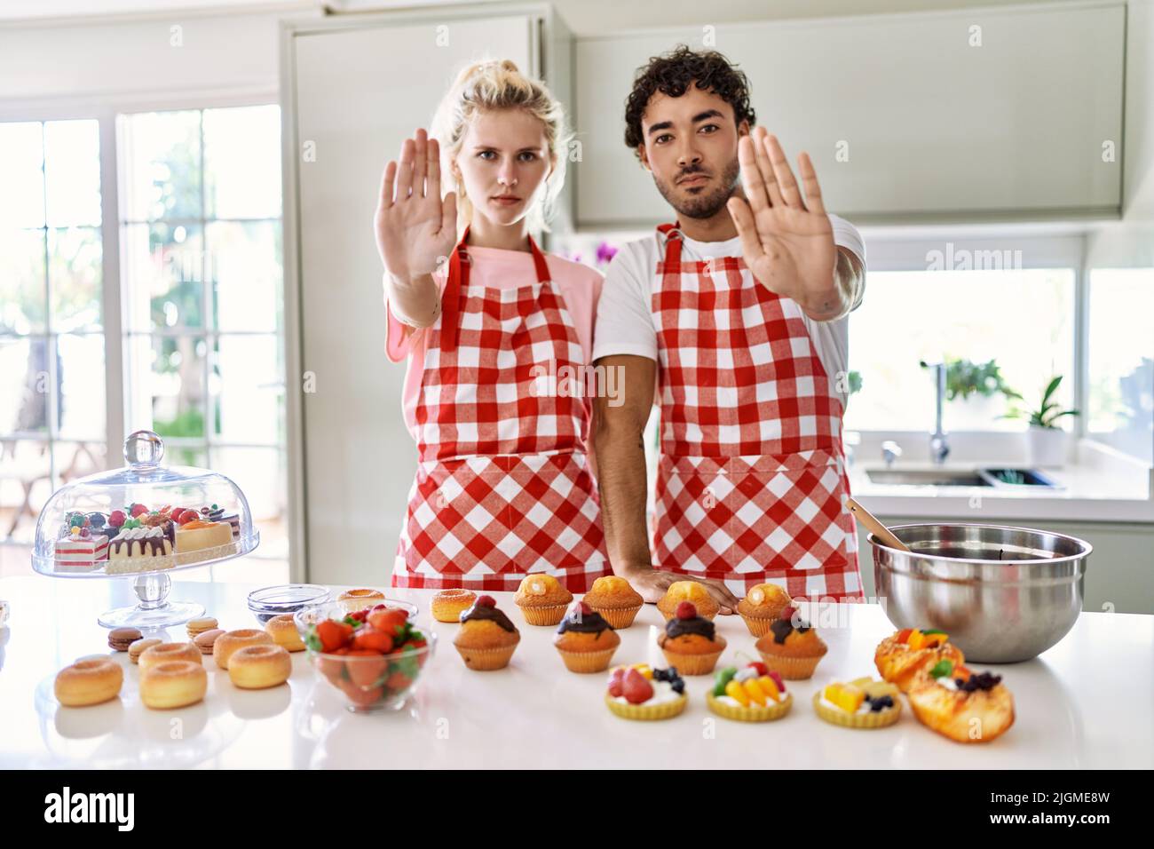 Couple of wife and husband cooking pastries at the kitchen doing stop ...