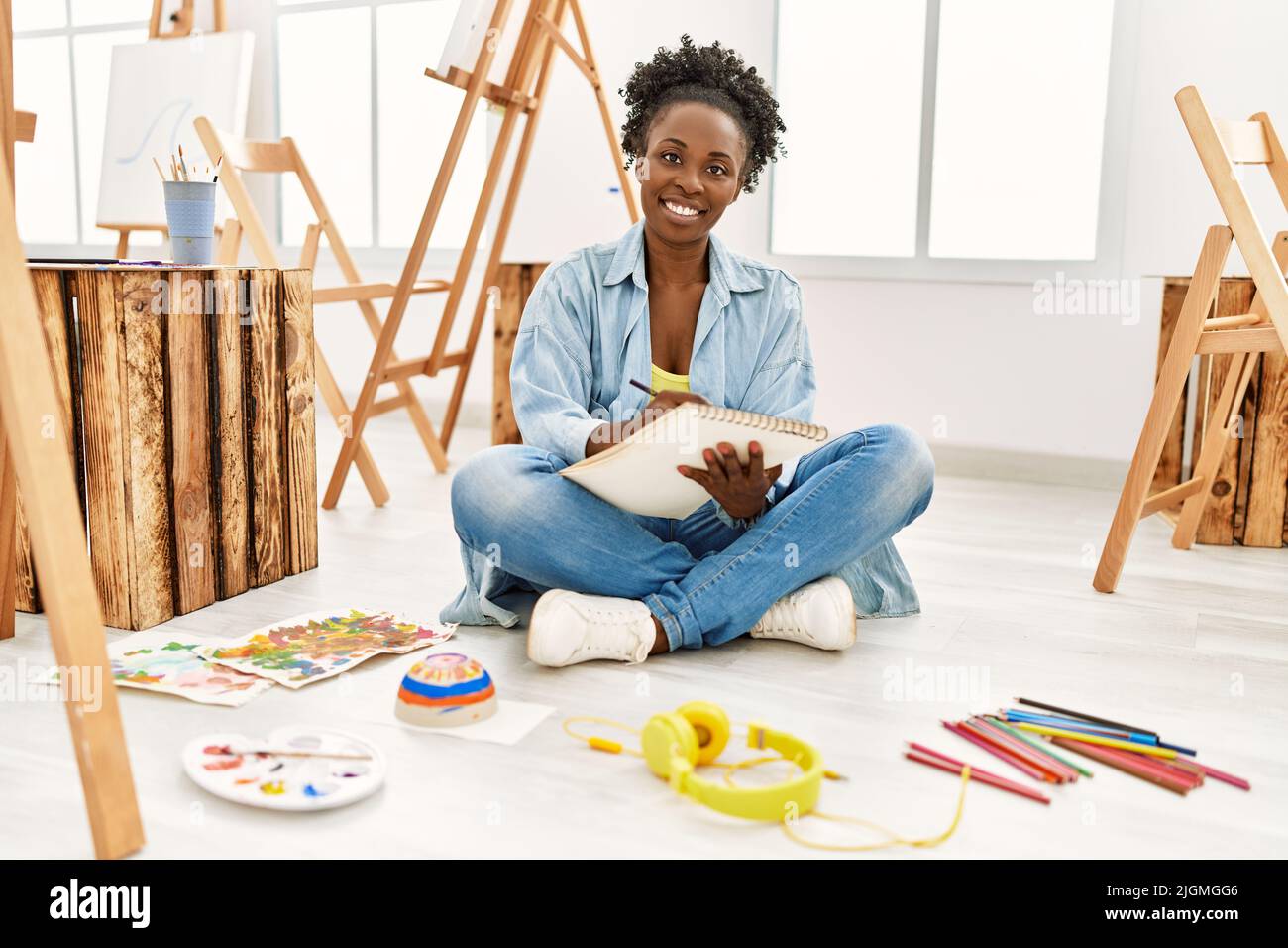 Young african american artist woman smiling happy drawing at art studio ...