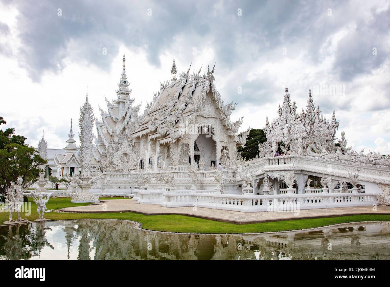 The modern Wat Rong Khun or  WHITE TEMPLE built by the artist Chalermachai Kositpipat is both Hindu and Buddhist - CHIANG RAI, THAILAND Stock Photo