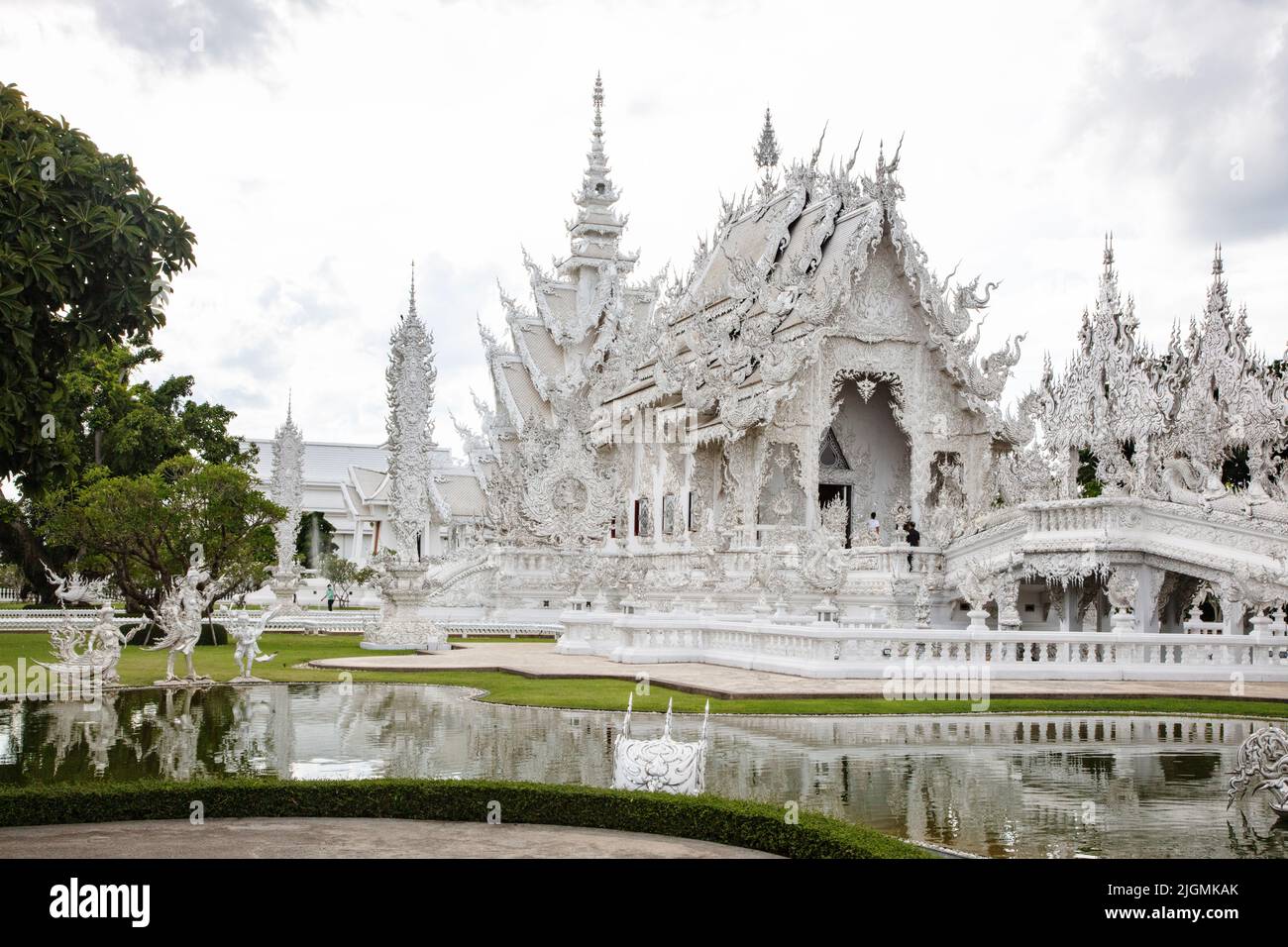 The modern Wat Rong Khun or  WHITE TEMPLE built by the artist Chalermachai Kositpipat is both Hindu and Buddhist - CHIANG RAI, THAILAND Stock Photo