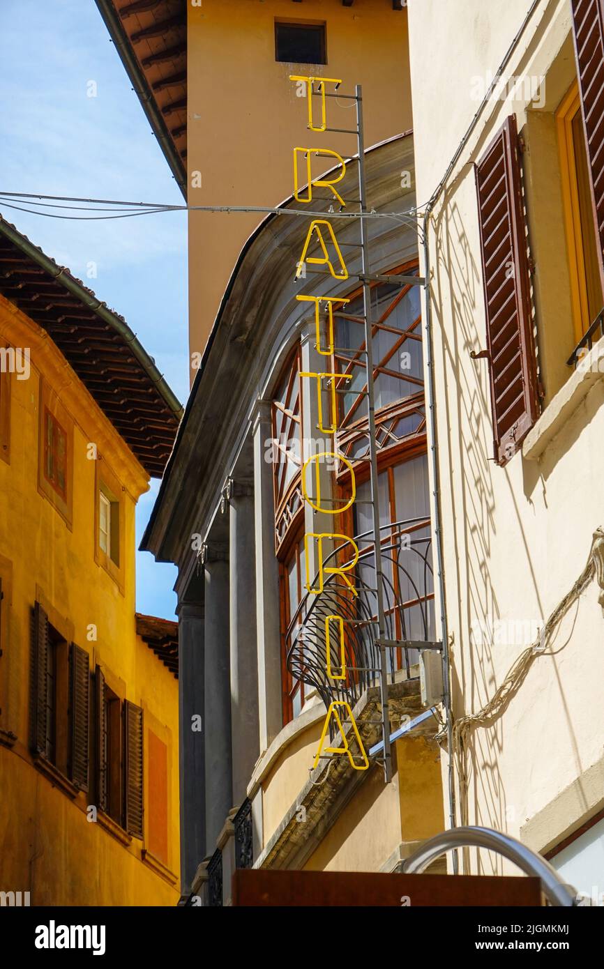Trattoria sign, neon letters on the side of a building in Florence, Italy. Stock Photo