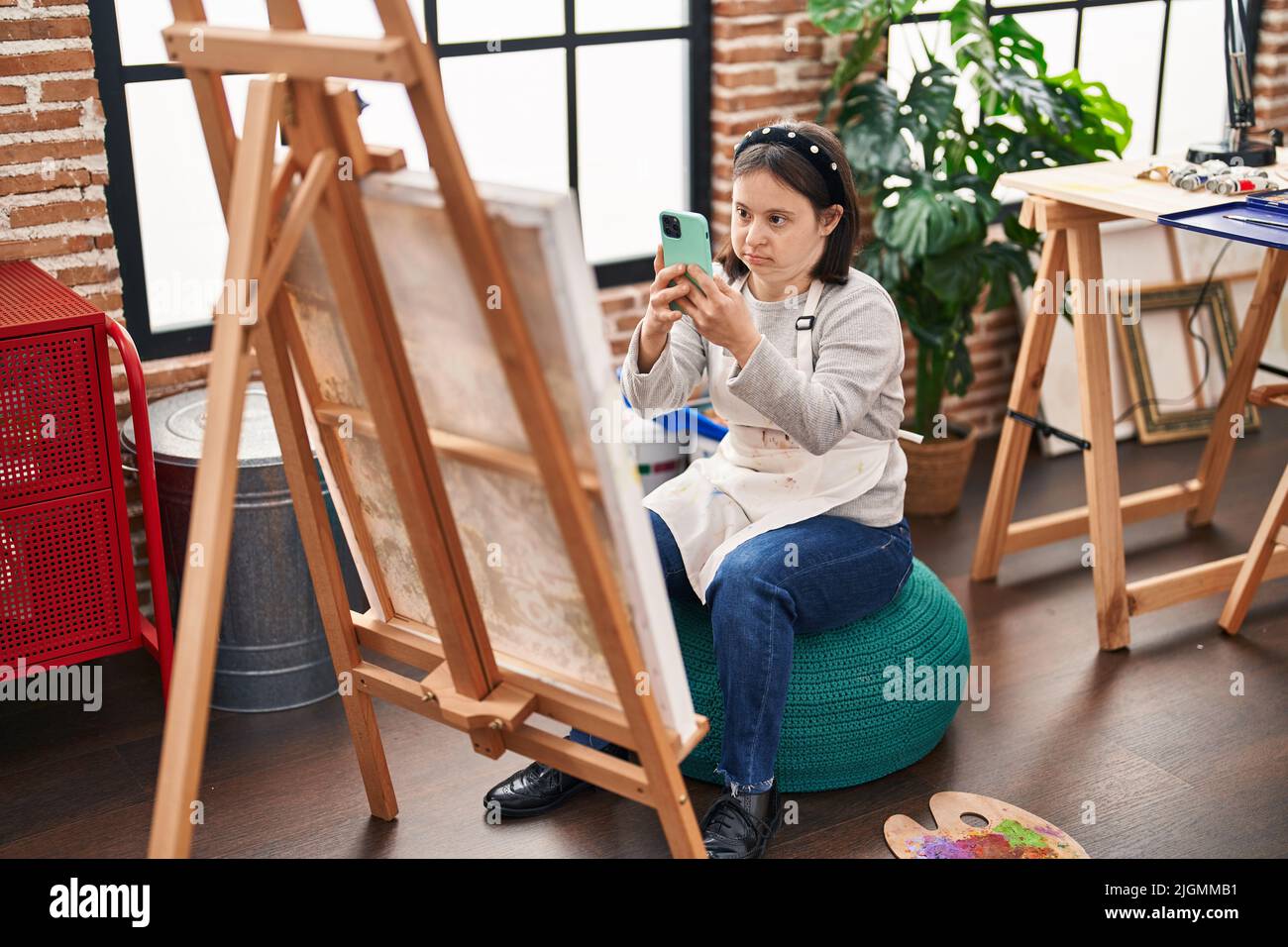 young-woman-with-down-syndrome-artist-make-photo-by-smartphone-to-draw