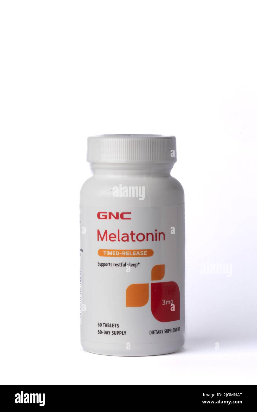 Davis, CA, July 9, 2022. Bottle of CNC Melatonin time-release 3mg against white background, centered, front view. Melatonin is a hormone used to help Stock Photo