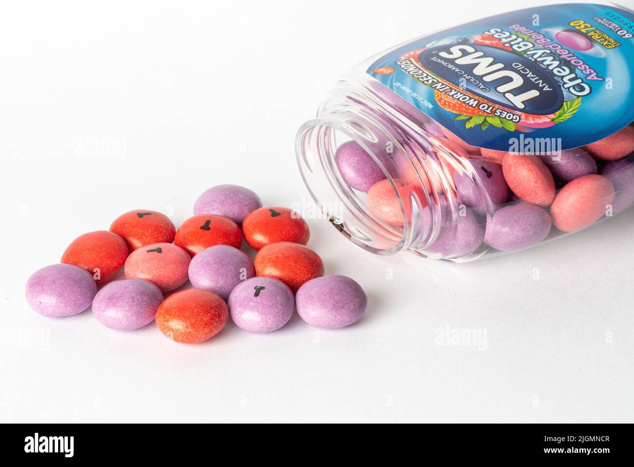 Davis, CA, July 9, 2022. Bottle of Tums antiacid chewy bites against white background, sideways, with tablets spilling out. Calcium Carbonate is a sub Stock Photo