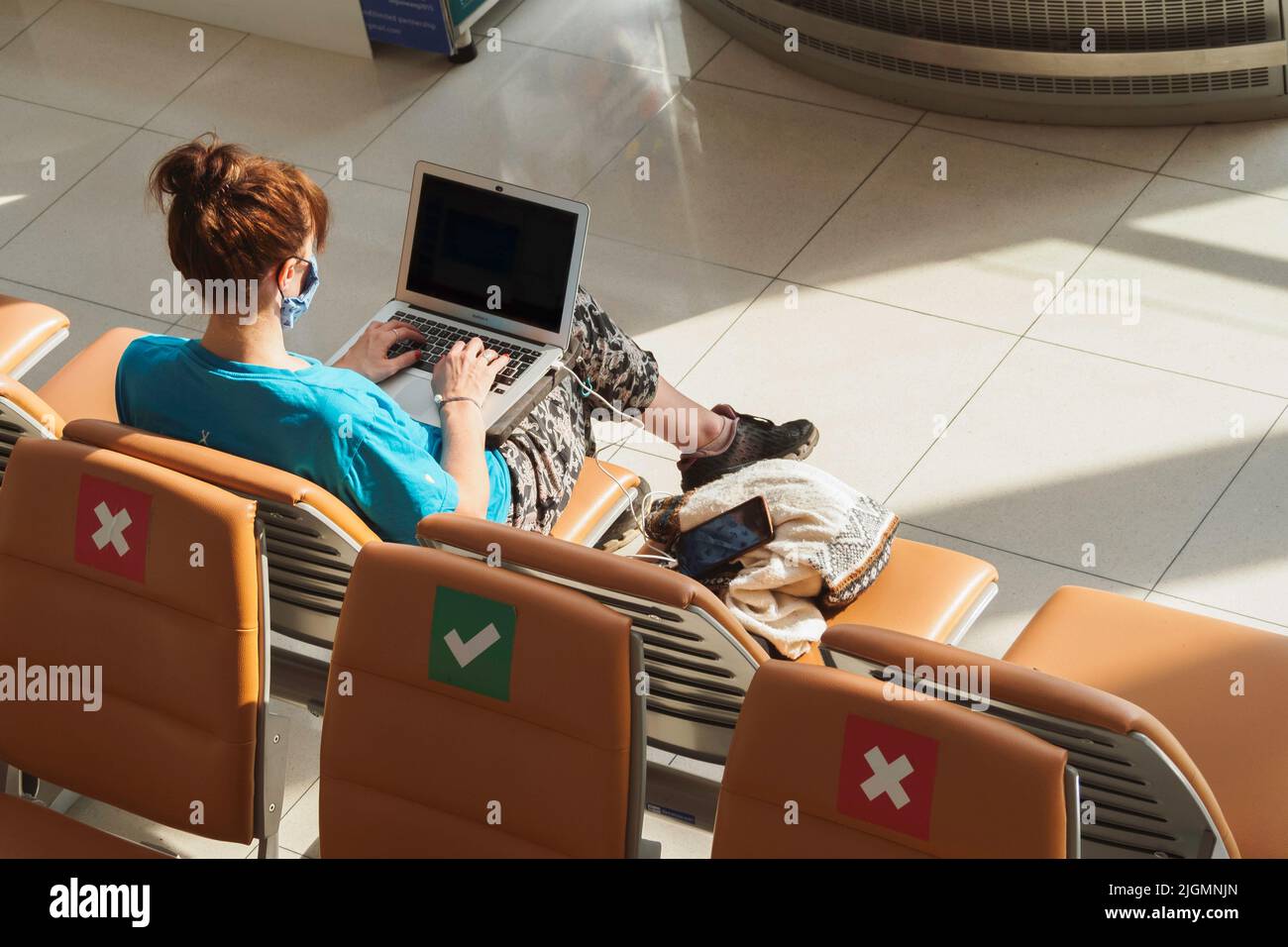 Bangkok, Thailand - May 2, 2022 : tourist visitors working on computer and waiting for airplane flight at the gate in suvarnabhumi airport. Stock Photo