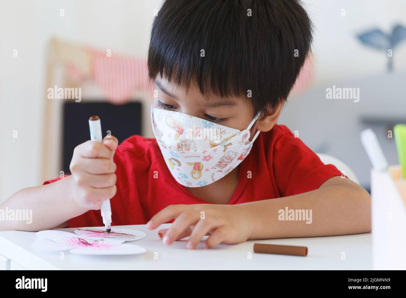 student boy playing color pen to drawing and painting in nursery classroom at kindergarten school. preschool children education. Stock Photo