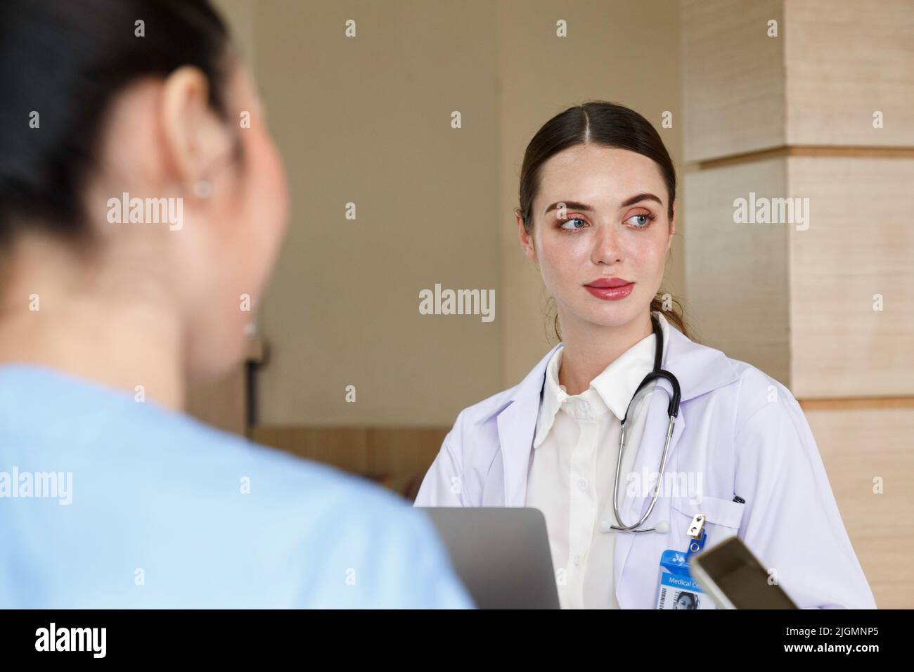 Team doctor, nurse and internship doctor talking and discussing about surgery treatment patient’s case while sitting in the meeting room office in hos Stock Photo