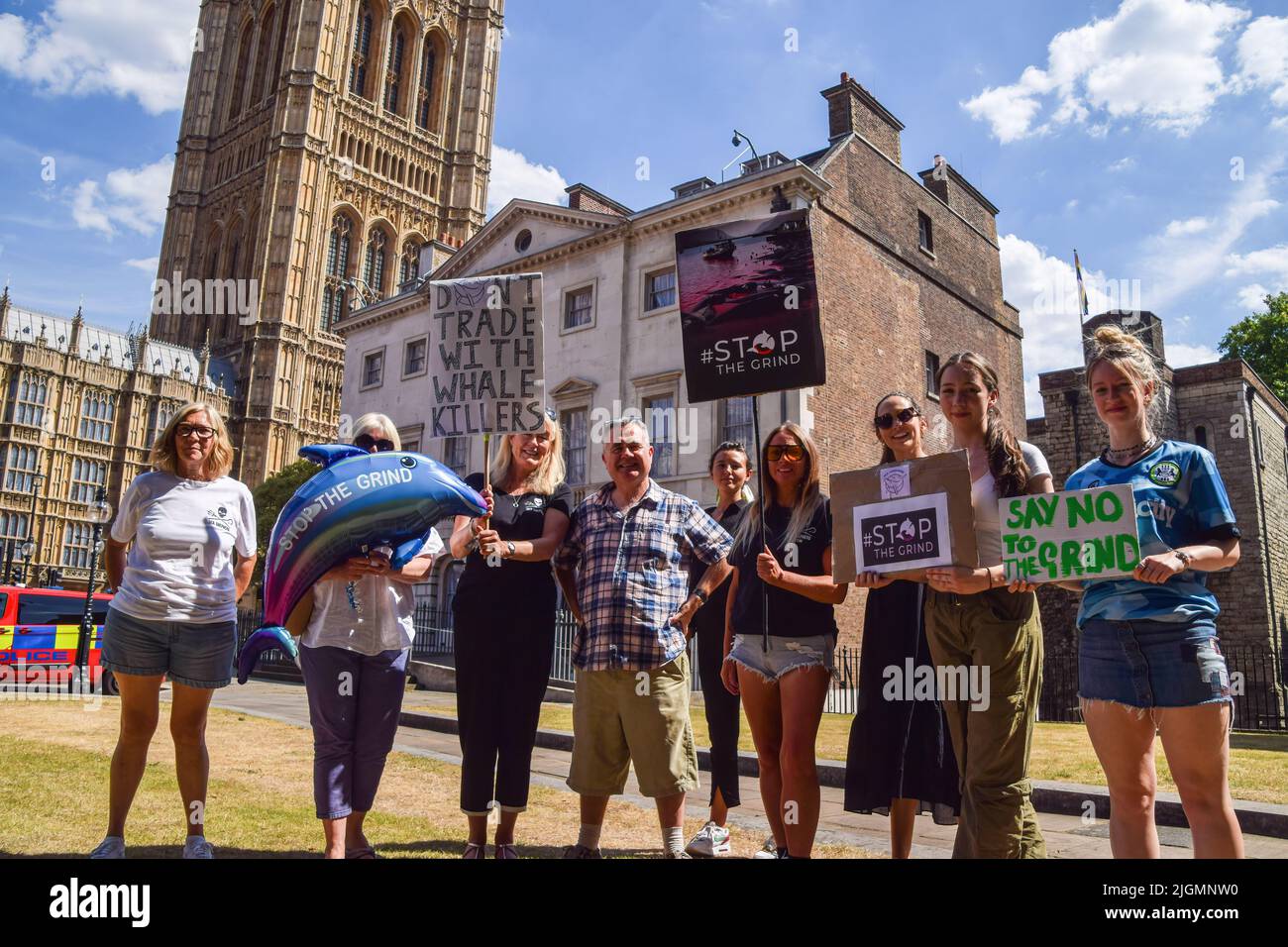 London, UK. 11th July, 2022. Dominic Dyer (center) from the wildlife conservation charity Born Free stands with protesters holding placards demanding an end to dolphin and whale hunts, during the demonstration. Ocean and marine wildlife conservation organization Sea Shepherd staged a rally outside the Parliament as MPs debated a petition to suspend trade with the Faroe Islands until they end brutal whale and dolphin hunts, known as the 'Grind'. Credit: SOPA Images Limited/Alamy Live News Stock Photo