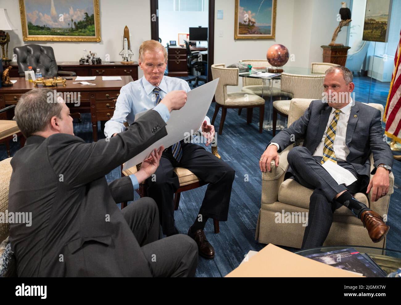 NASA Administrator Bill Nelson, center, and Associate Administrator for NASA's Science Mission Directorate, Thomas Zurbuchen, right, react to the first full-color images from NASA's James Webb Space Telescope in a preview meeting with Webb project scientist at the Space Telescope Science Institute, Klaus Pontoppidan, left, Monday, July 11, 2022 at the Mary W. Jackson NASA Headquarters building in Washington. The first images and spectroscopic data from the world's largest and most powerful space telescope, set to be released July 11 and 12, will demonstrate Webb at its full power, as it begins Stock Photo