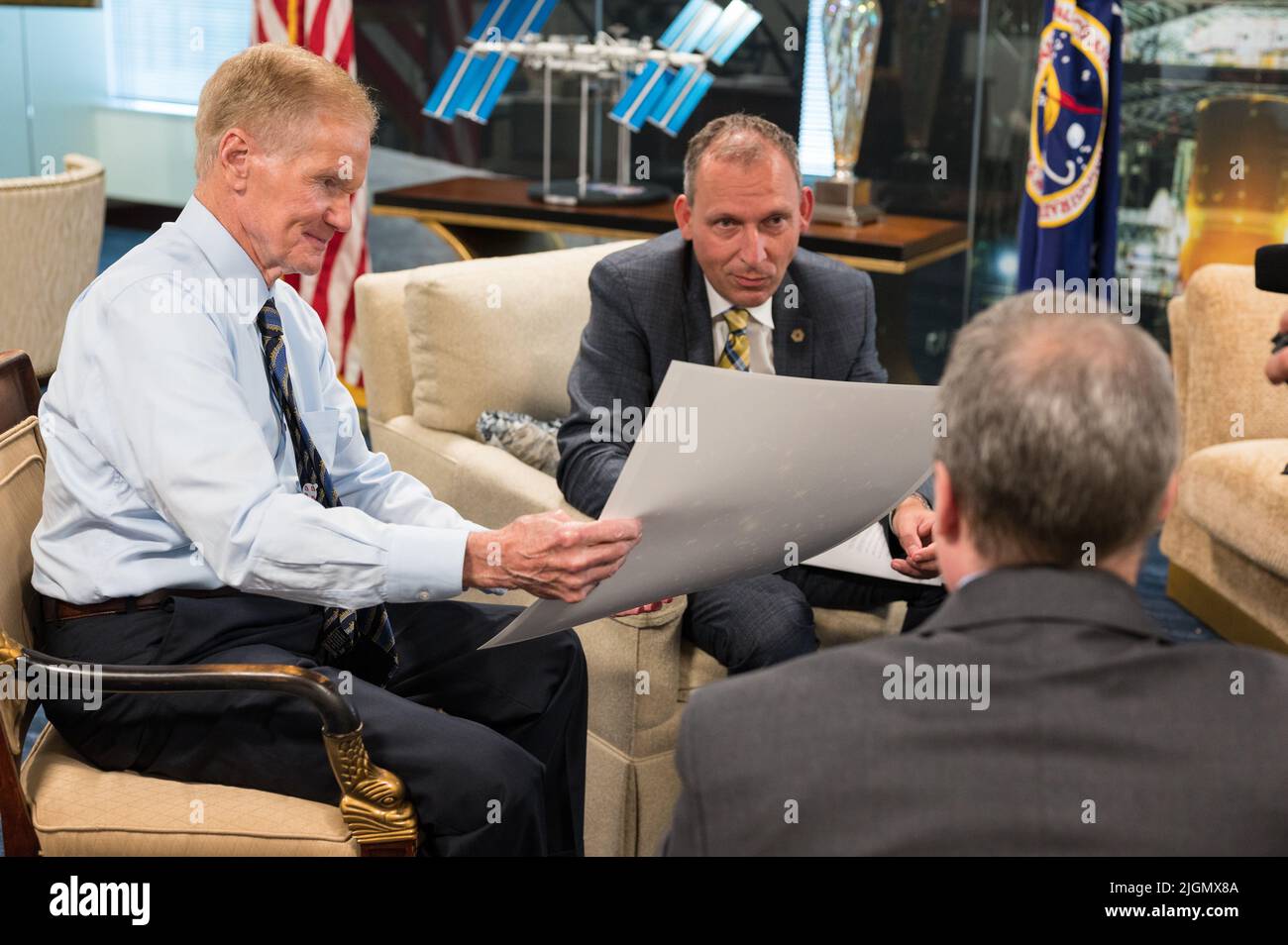 NASA Administrator Bill Nelson, left, and Associate Administrator for NASA's Science Mission Directorate, Thomas Zurbuchen, center, react to the first full-color images from NASA's James Webb Space Telescope in a preview meeting with Webb project scientist at the Space Telescope Science Institute, Klaus Pontoppidan, right, Monday, July 11, 2022 at the Mary W. Jackson NASA Headquarters building in Washington. The first images and spectroscopic data from the world's largest and most powerful space telescope, set to be released July 11 and 12, will demonstrate Webb at its full power, as it begins Stock Photo