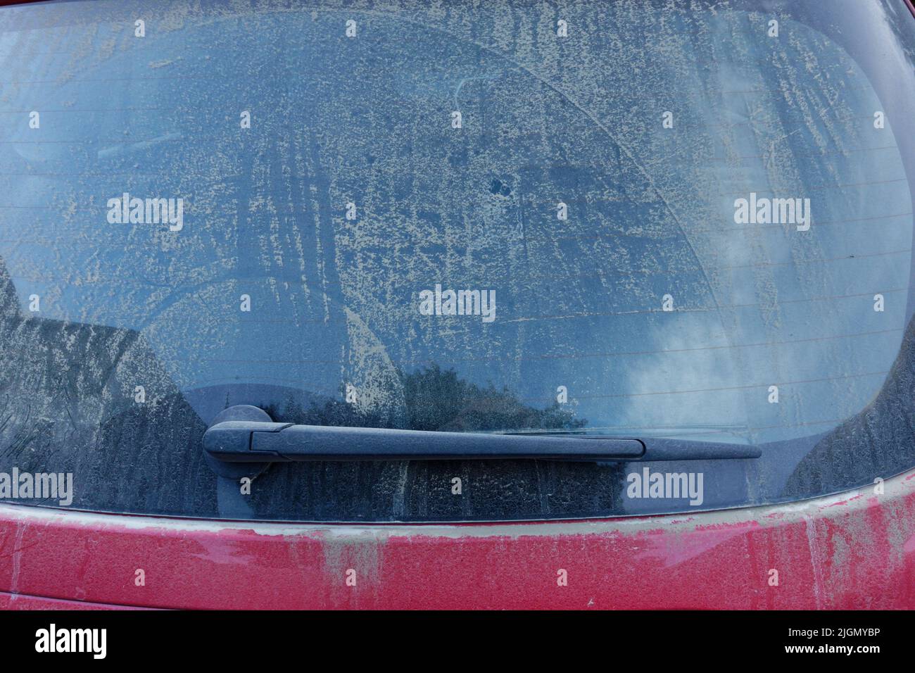 A dirty rear window obscuring a rear view of traffic for the driver on a hatchback car. Driving blind. Stock Photo