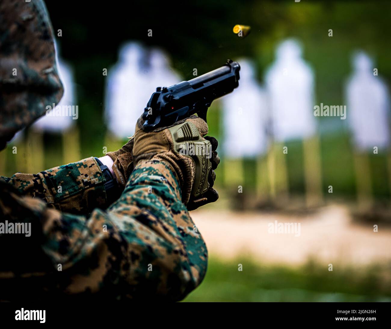 A Marine with Guard Company, Marine Barracks Washington, fires the M9