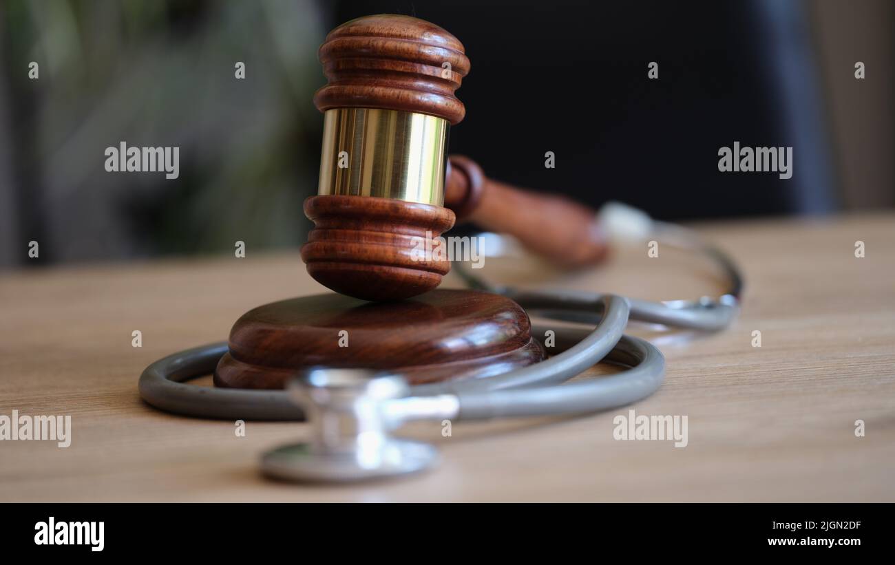 Judge gavel and medical stethoscope on office desk Stock Photo