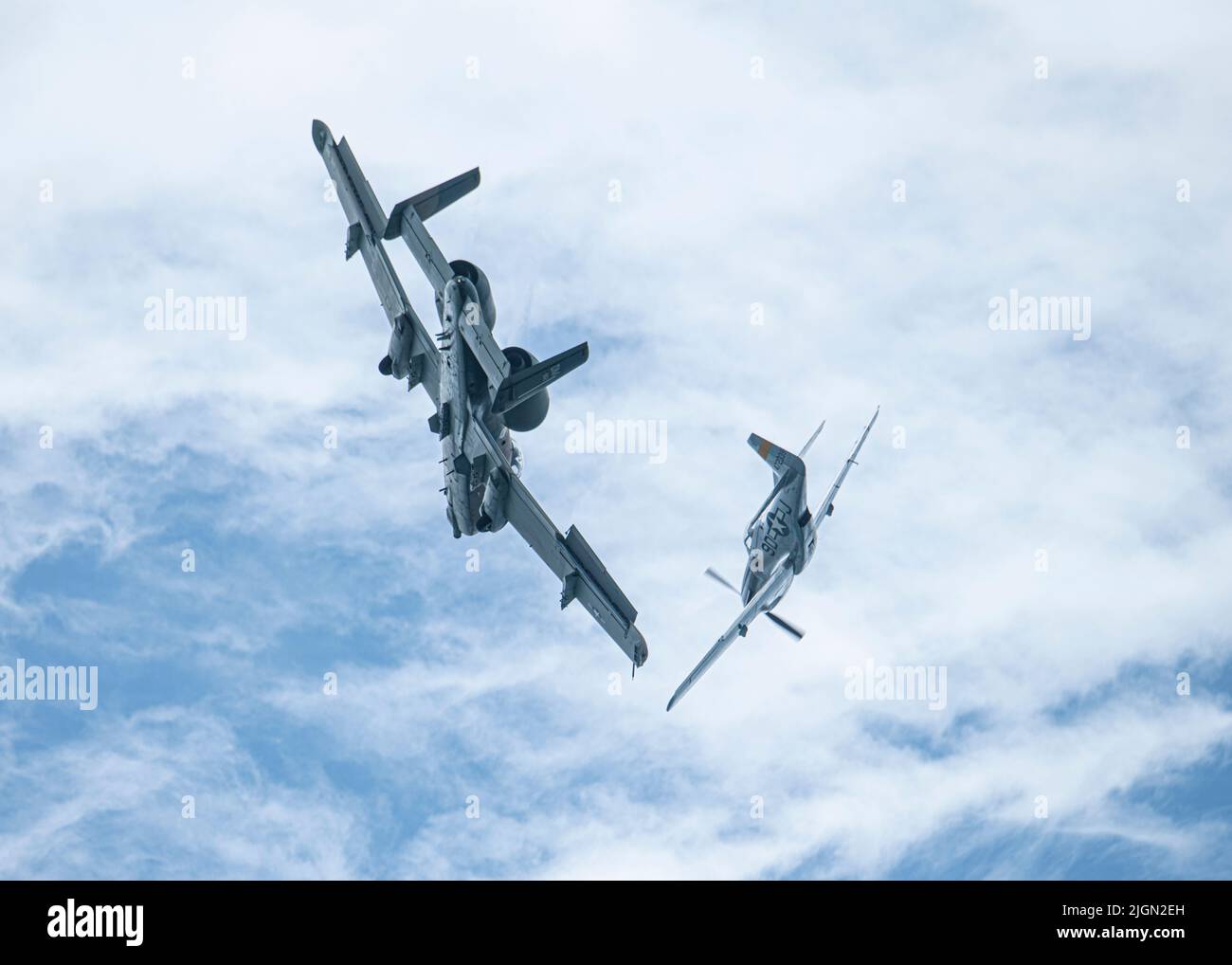 A U.S. Air Force A10 Thunderbolt II and a P51 Mustang fly over Fort