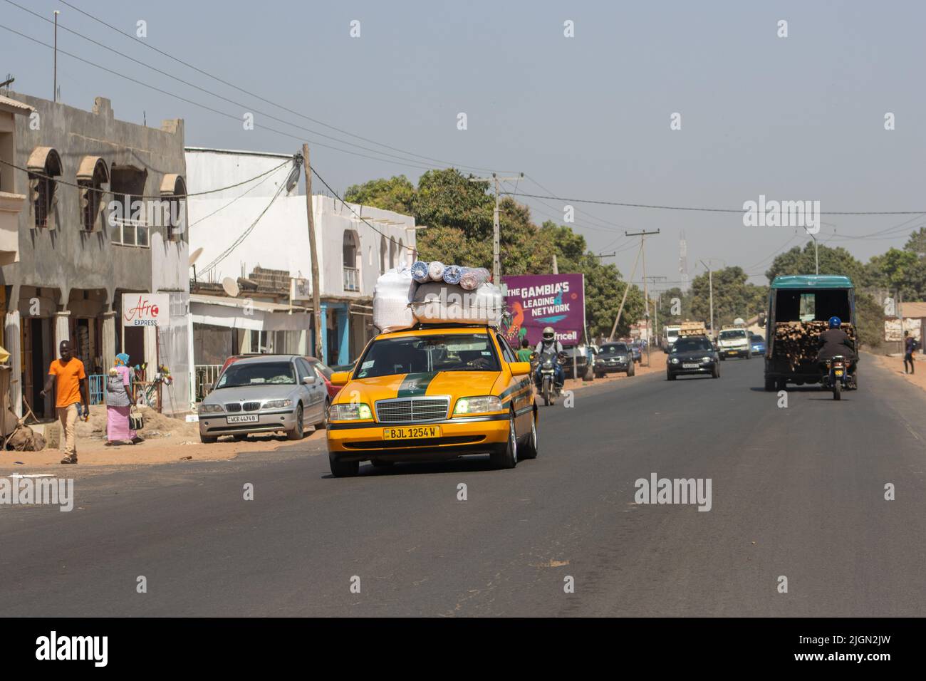 SERRAKUNDA, THE GAMBIA - FEBRUARY 7, 2022 famous yellow and green taxi
