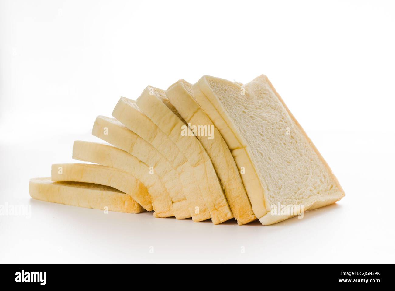 Loaf of sliced white bread on white background Stock Photo - Alamy