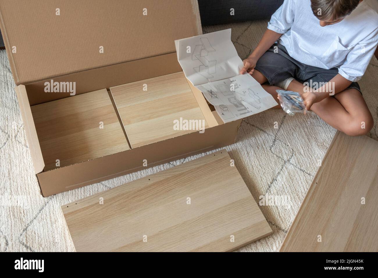 Vilnius, Lithuania July 7, 2022 Teenage boy reading instruction how