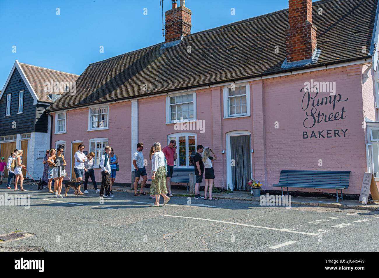 A queue of customers outside the Pump Street bakery in Orford, Suffolk, UK Stock Photo