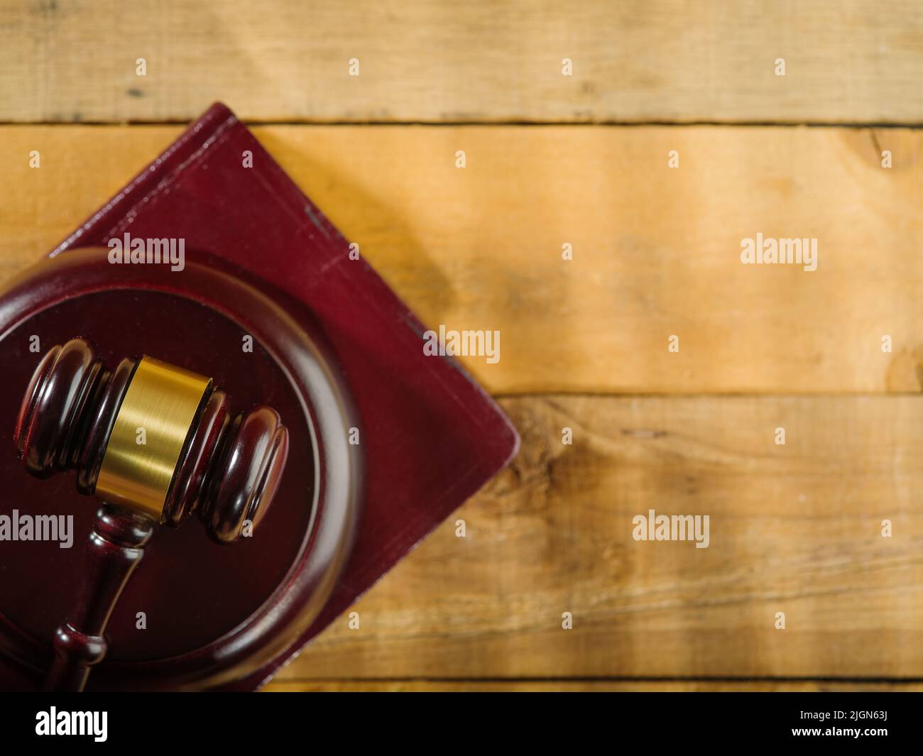 Red gavel of the judge on a wooden background. Low angle view. Constitution, justice, rule of law, judge, lawyer, constitution, Themis. There is free Stock Photo