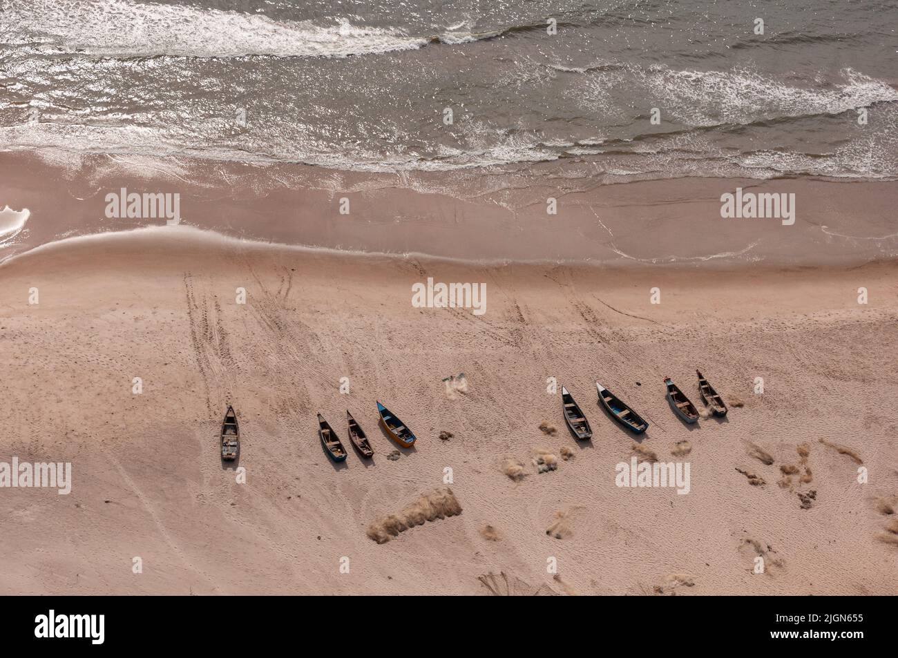 Helicopter ferry flight from Luanda to Point Noire, a birds eye view of a few beached boats in the afternoon sun. Stock Photo