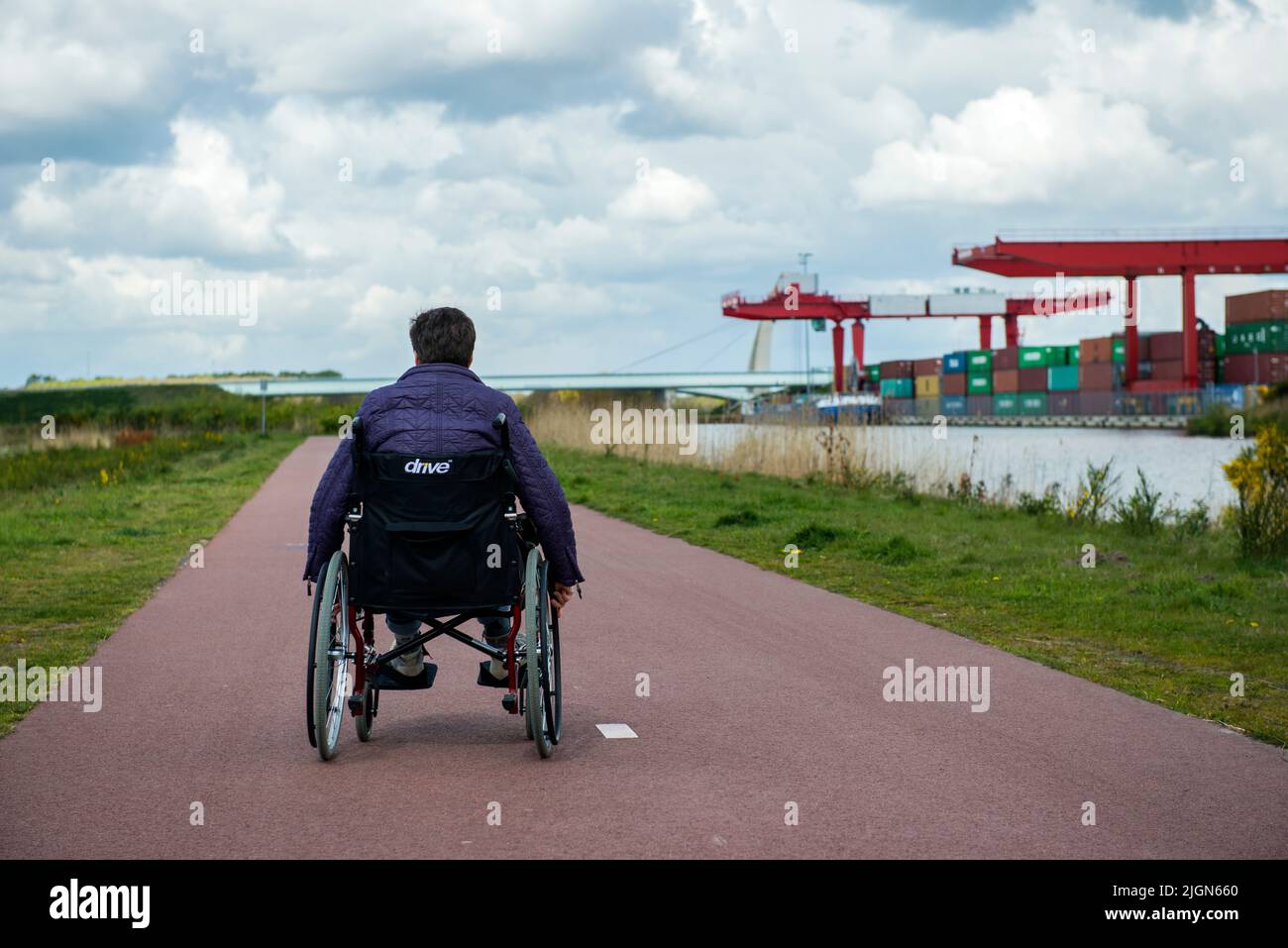 Tilburg, Netherlands. Female multiple sclerosis patient dealing with her condition by on and off using a wheelchair to get along. Stock Photo