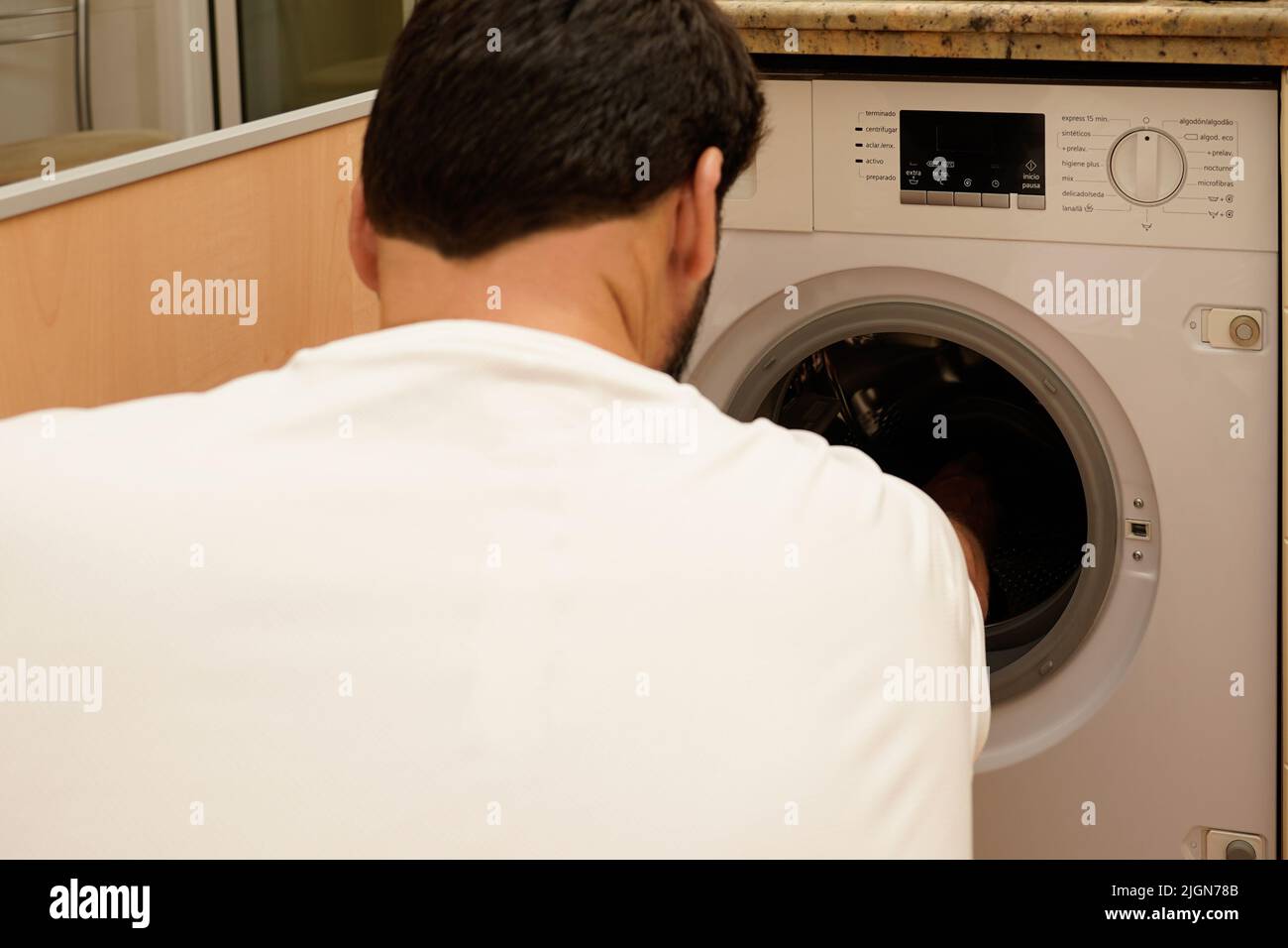 Man washing clothes. Concept of rising energy prices. Concept of electricity consumption Stock Photo