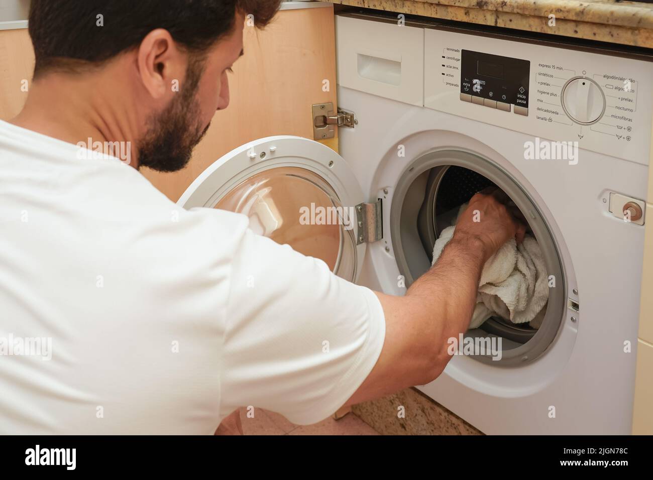 Man washing clothes. Concept of rising energy prices. Concept of