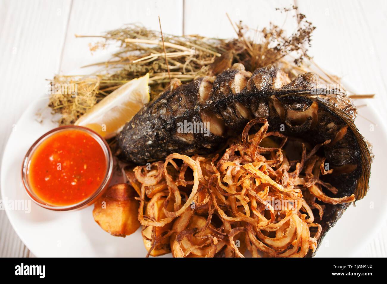 Grilled fish with onion rings and ketchup flat lay Stock Photo - Alamy