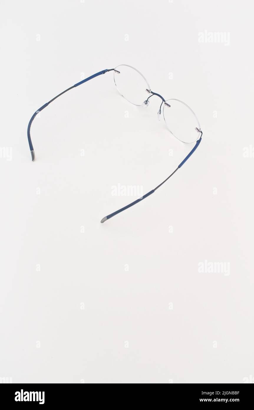 frame less eyeglasses on a white desk with copy space vision care