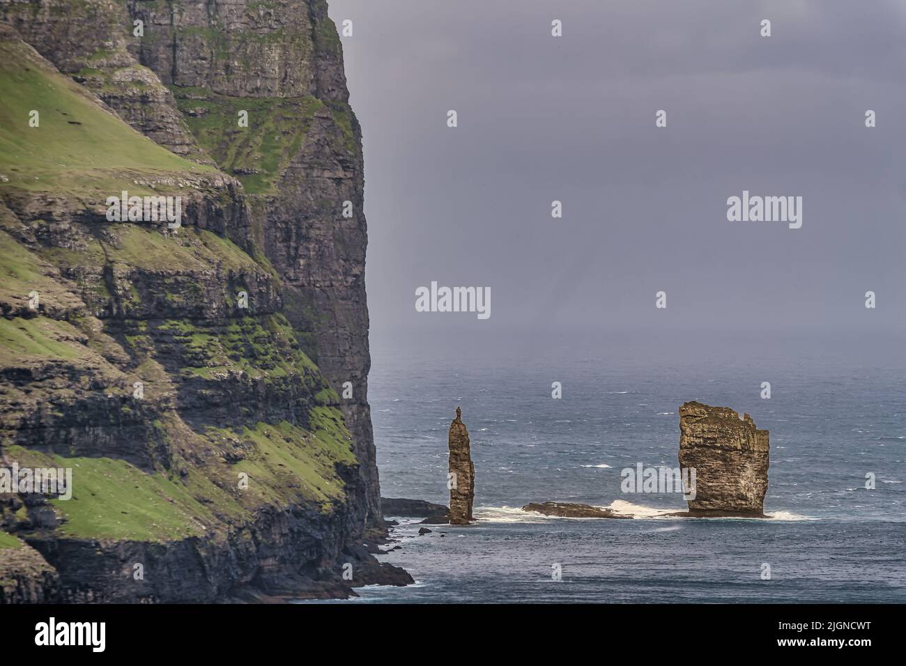 Risin og Kellingin rock formations on the coast of Eysturoy Island. Coastline cliffs landscape. Eidi, Faroe Islands Stock Photo