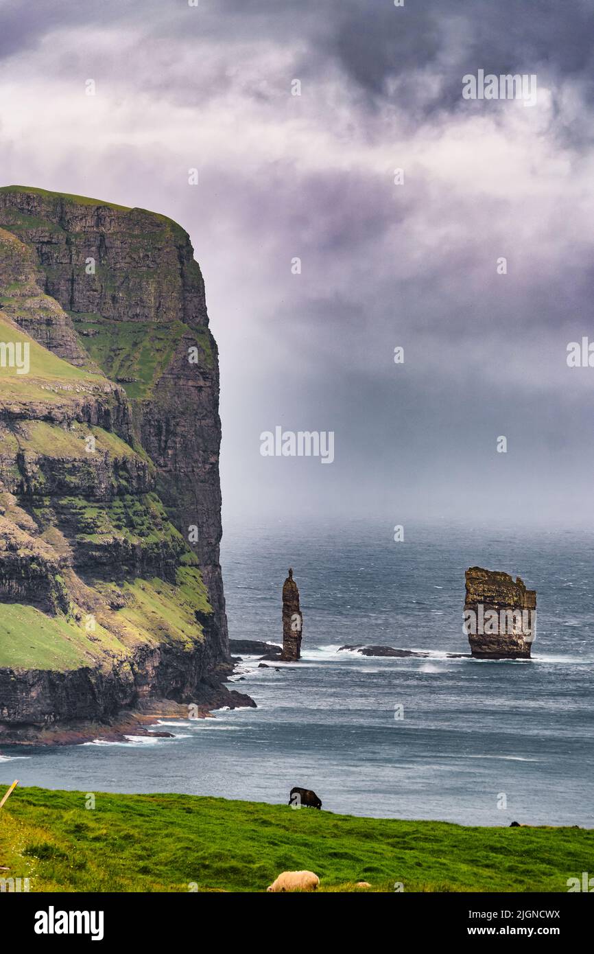 Risin og Kellingin rock formations on the coast of Eysturoy Island. Coastline cliffs landscape. Eidi, Faroe Islands Stock Photo