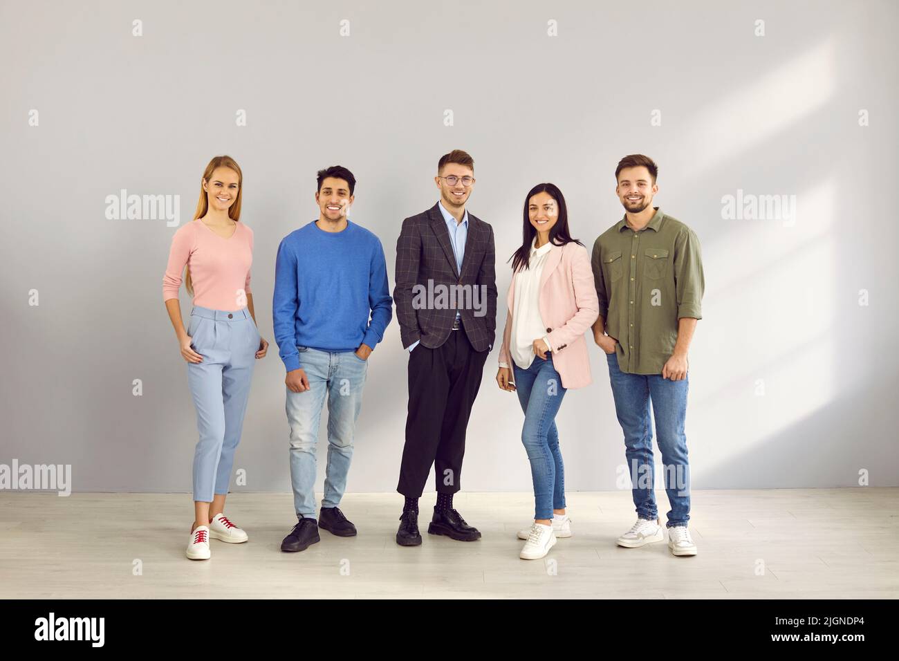 Smiling multiracial employees pose together in office Stock Photo