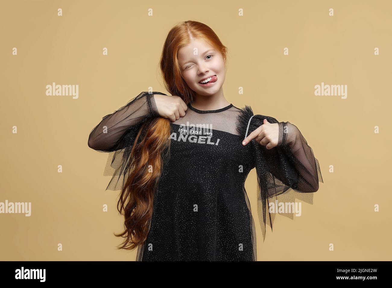 teen girl with long red hair in black angel dress Stock Photo - Alamy