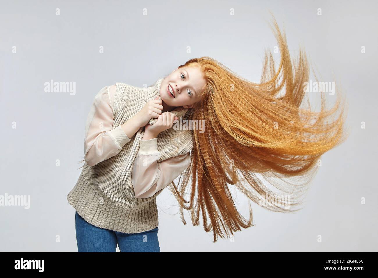 teen girl with long red hair in Studio on white background Stock Photo ...