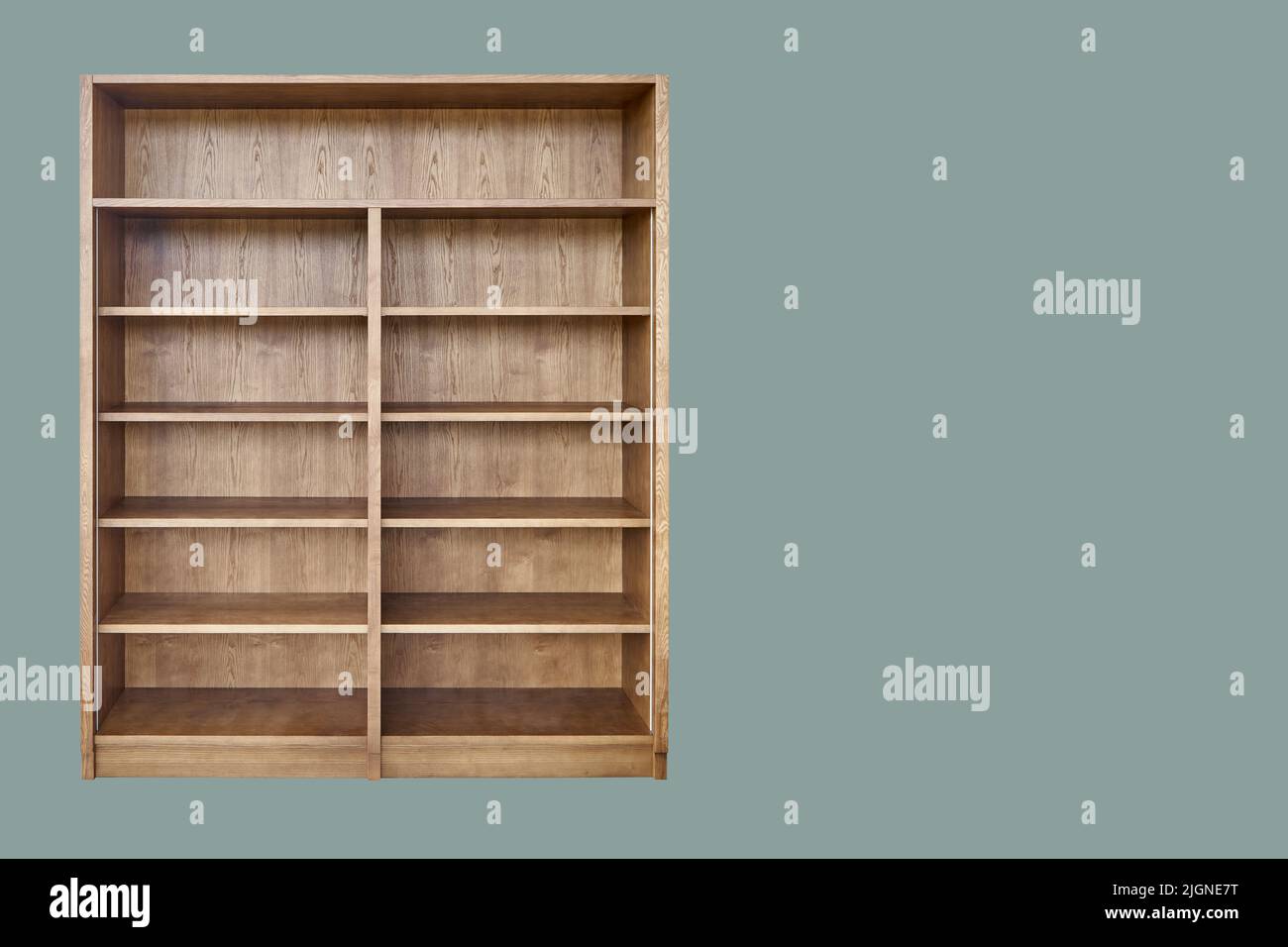 Wooden bookcase made of toned ash veneered MDF isolated on green background Stock Photo