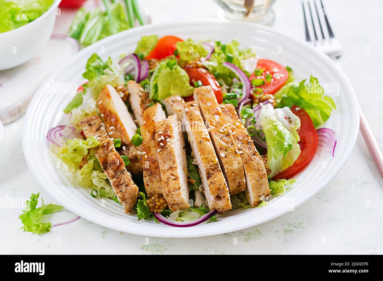 Salad with grilled chicken breast. Fresh vegetable salad with chicken meat. Healthy lunch menu. Diet food. Stock Photo