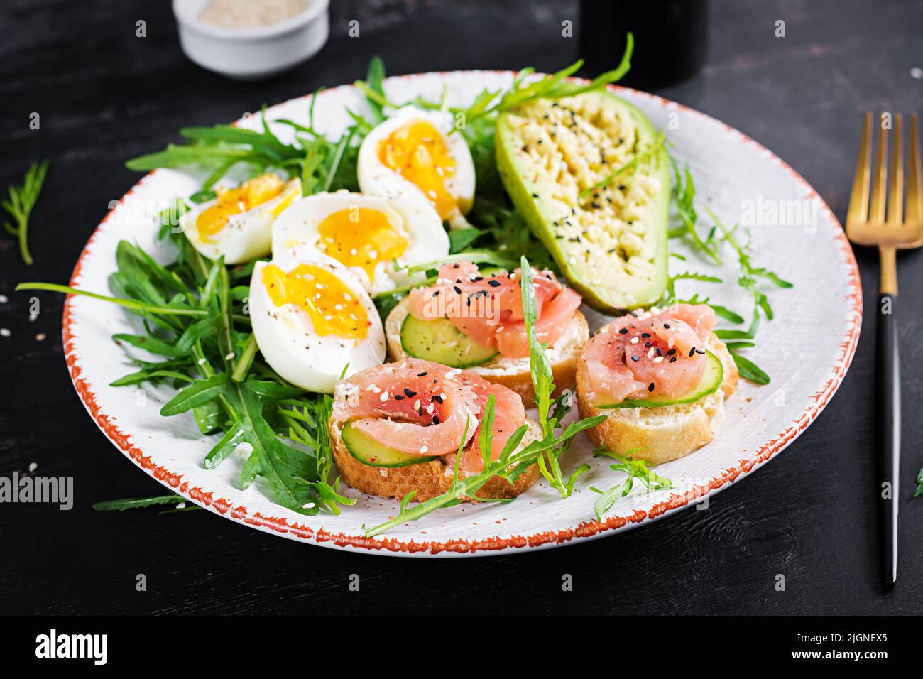 Sandwiches with salt salmon and boiled eggs and avocado. Keto, ketogenic diet breakfast or lunch. Stock Photo