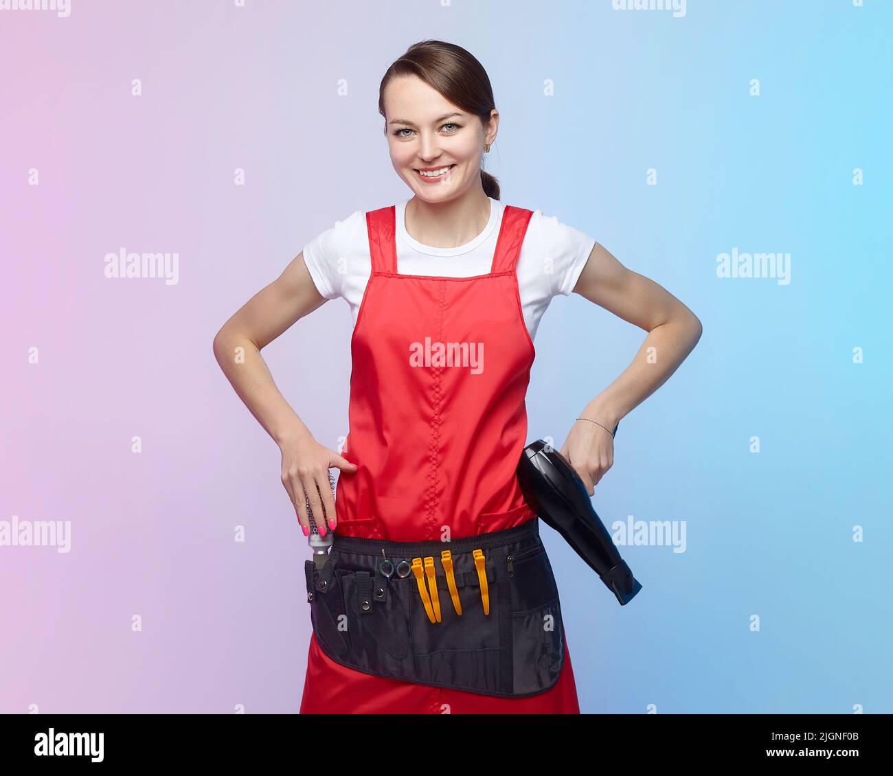 smiling hairdresser girl posing with hair dryer Stock Photo - Alamy